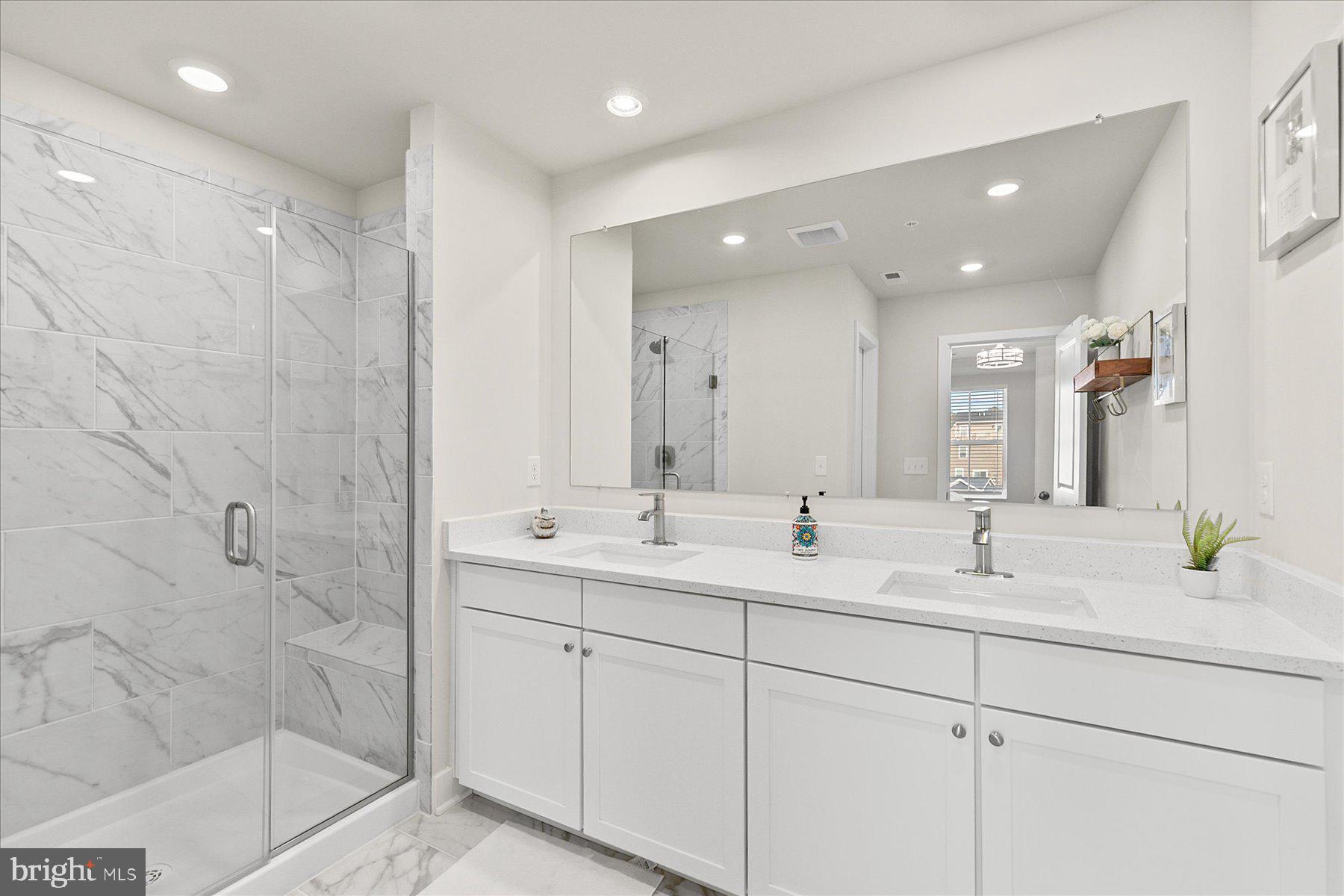 9503 Seascape Lane, Unit 4 Berlin, MD 21811 - Photo 31 of 52 a bathroom with double sink and a mirror