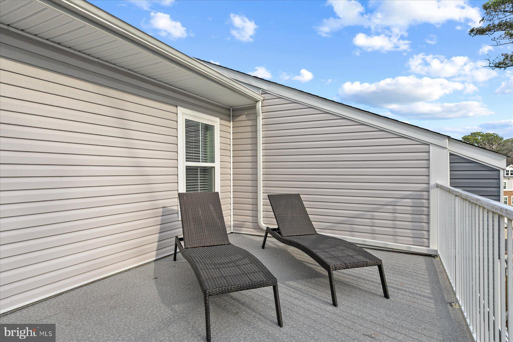 9503 Seascape Lane, Unit 4 Berlin, MD 21811 - Photo 43 of 52 a view of a patio with table and chairs and wooden floor