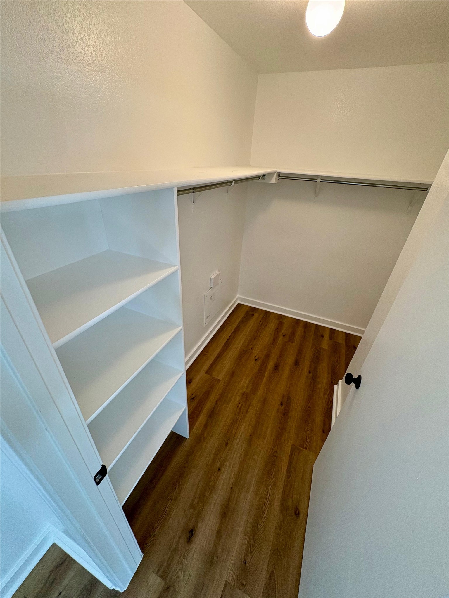8003 Bannock Lane Austin, TX 78747 - Photo 20 of 40 Walk in closet with dark wood-style floors