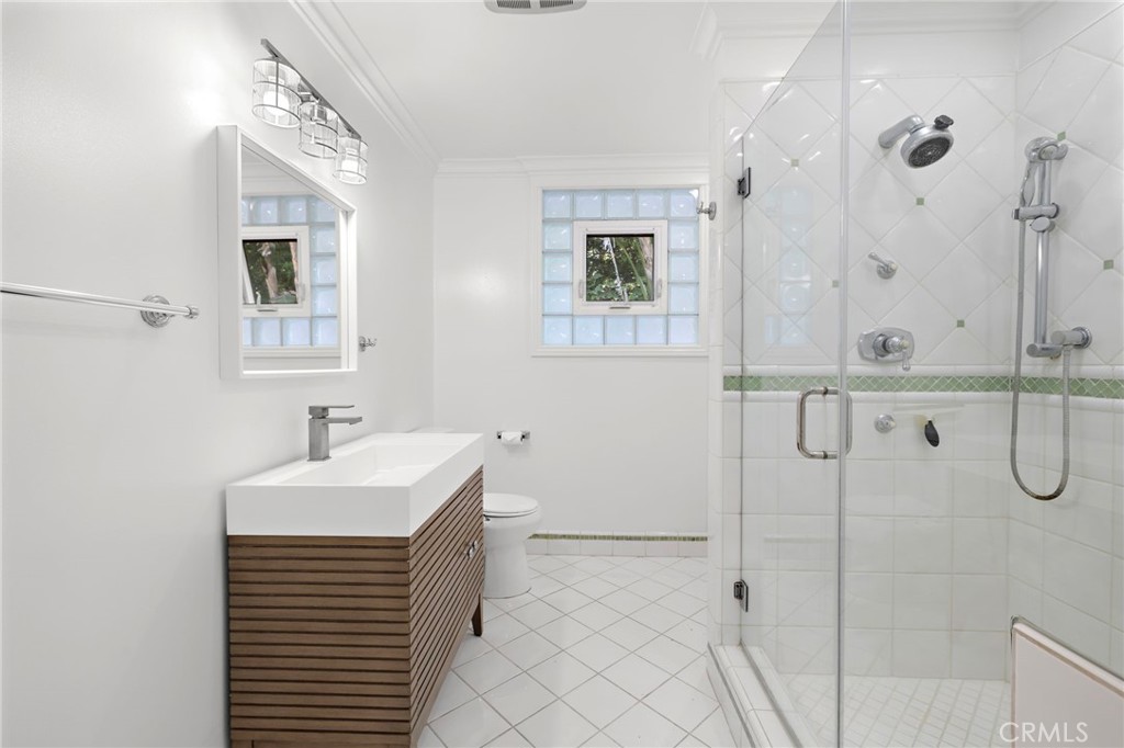 273 Cecil Place Costa Mesa, CA 92627 - Photo 12 of 18 a bathroom with a sink a mirror and shower
