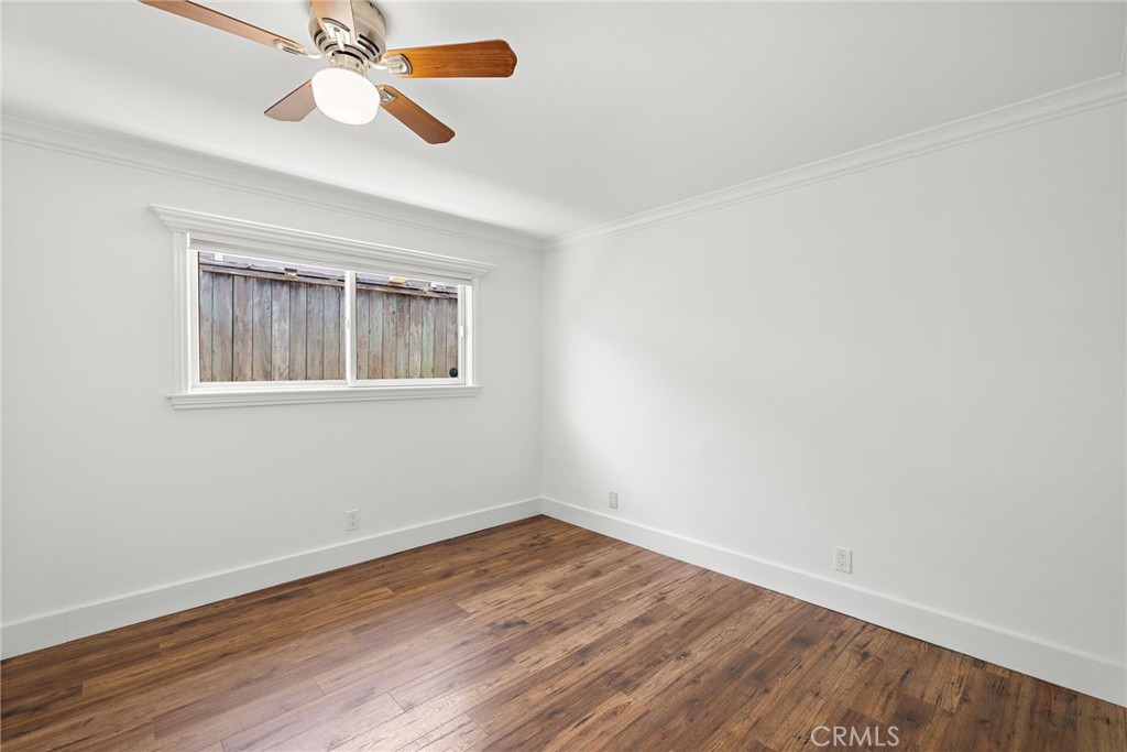 273 Cecil Place Costa Mesa, CA 92627 - Photo 13 of 18 a view of an empty room with wooden floor and a window