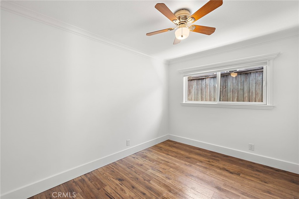 273 Cecil Place Costa Mesa, CA 92627 - Photo 14 of 18 an empty room with wooden floor and a ceiling fan