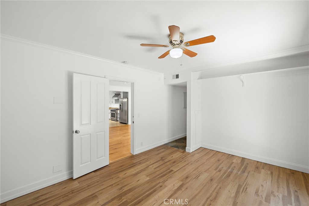 273 Cecil Place Costa Mesa, CA 92627 - Photo 16 of 18 an empty room with wooden floor and ceiling fan