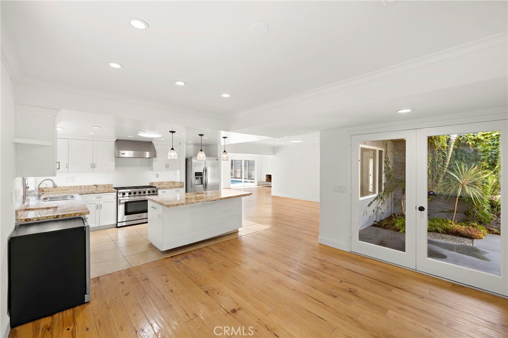 273 Cecil Place Costa Mesa, CA 92627 - Photo 4 of 18 a large kitchen with lots of counter top space and stainless steel appliances