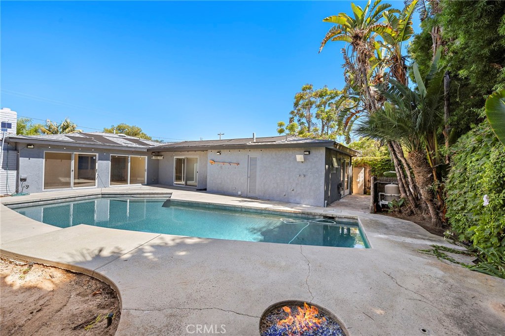 273 Cecil Place Costa Mesa, CA 92627 - Photo 8 of 18 a front view of a house with a yard and a garage