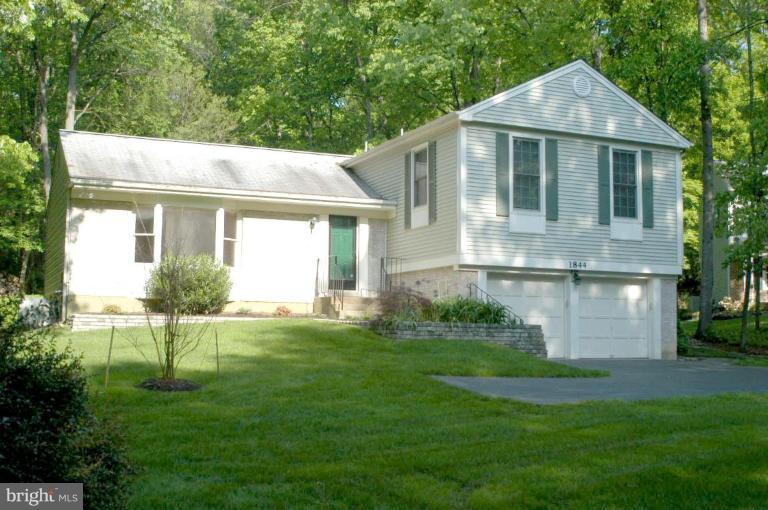 1844 Post Oak Trail Reston, VA 20191 - Photo 1 of 27 a view of a house with a yard and potted plants