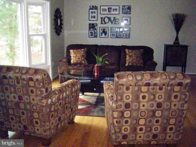 1844 Post Oak Trail Reston, VA 20191 - Photo 11 of 27 a living room with furniture and a fireplace