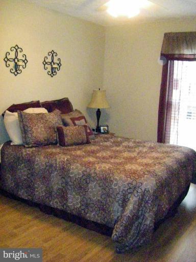 1844 Post Oak Trail Reston, VA 20191 - Photo 13 of 27 a bedroom with a bed and a window
