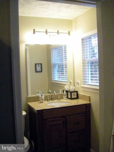 1844 Post Oak Trail Reston, VA 20191 - Photo 22 of 27 a bathroom with a sink and a mirror