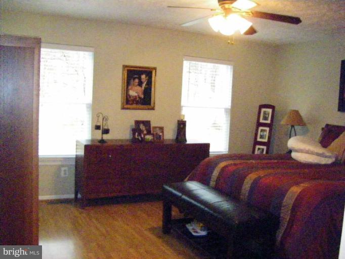1844 Post Oak Trail Reston, VA 20191 - Photo 7 of 27 a bed room with a bed and a chandelier
