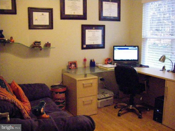 1844 Post Oak Trail Reston, VA 20191 - Photo 8 of 27 a view of a workspace with furniture and a window