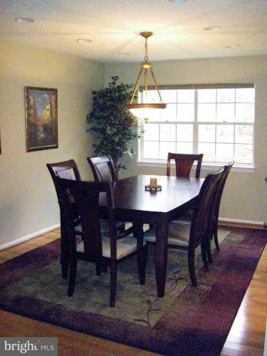 1844 Post Oak Trail Reston, VA 20191 - Photo 9 of 27 a view of a dining room with furniture window and wooden floor