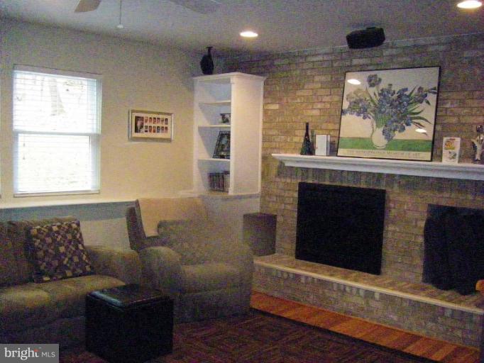 1844 Post Oak Trail Reston, VA 20191 - Photo 10 of 27 a living room with furniture and a fireplace