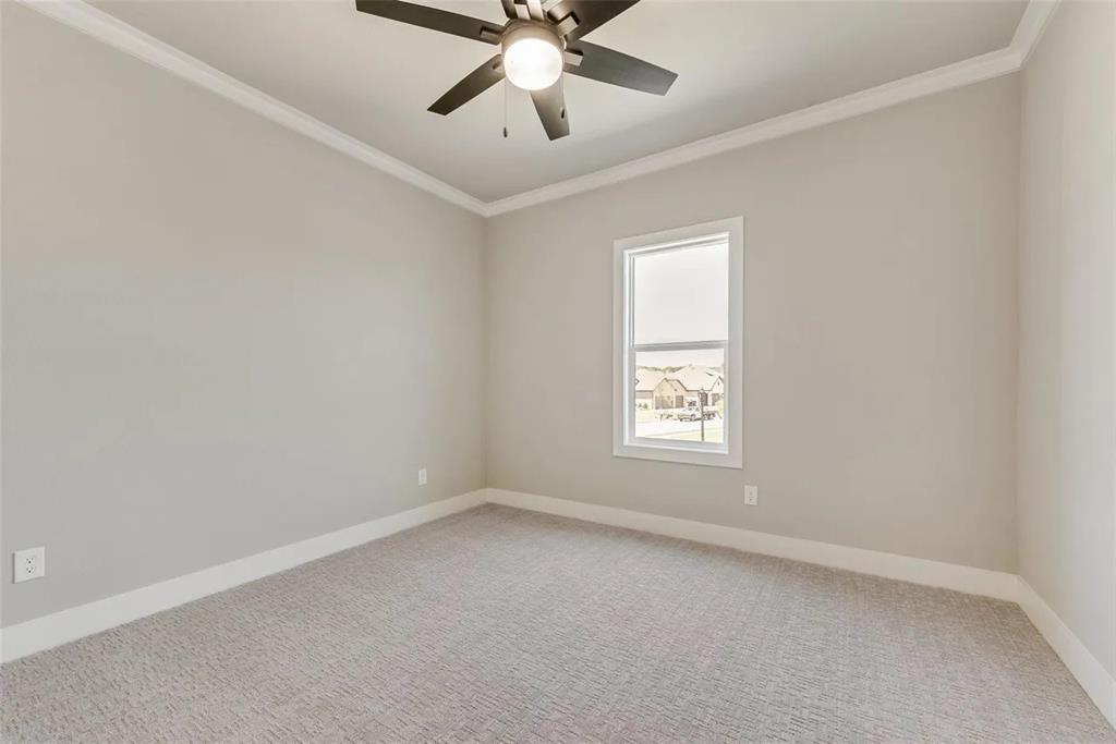 1327 Selby Road Van Alstyne, TX 75495 - Photo 12 of 32 Unfurnished room featuring ornamental molding, light carpet, and ceiling fan