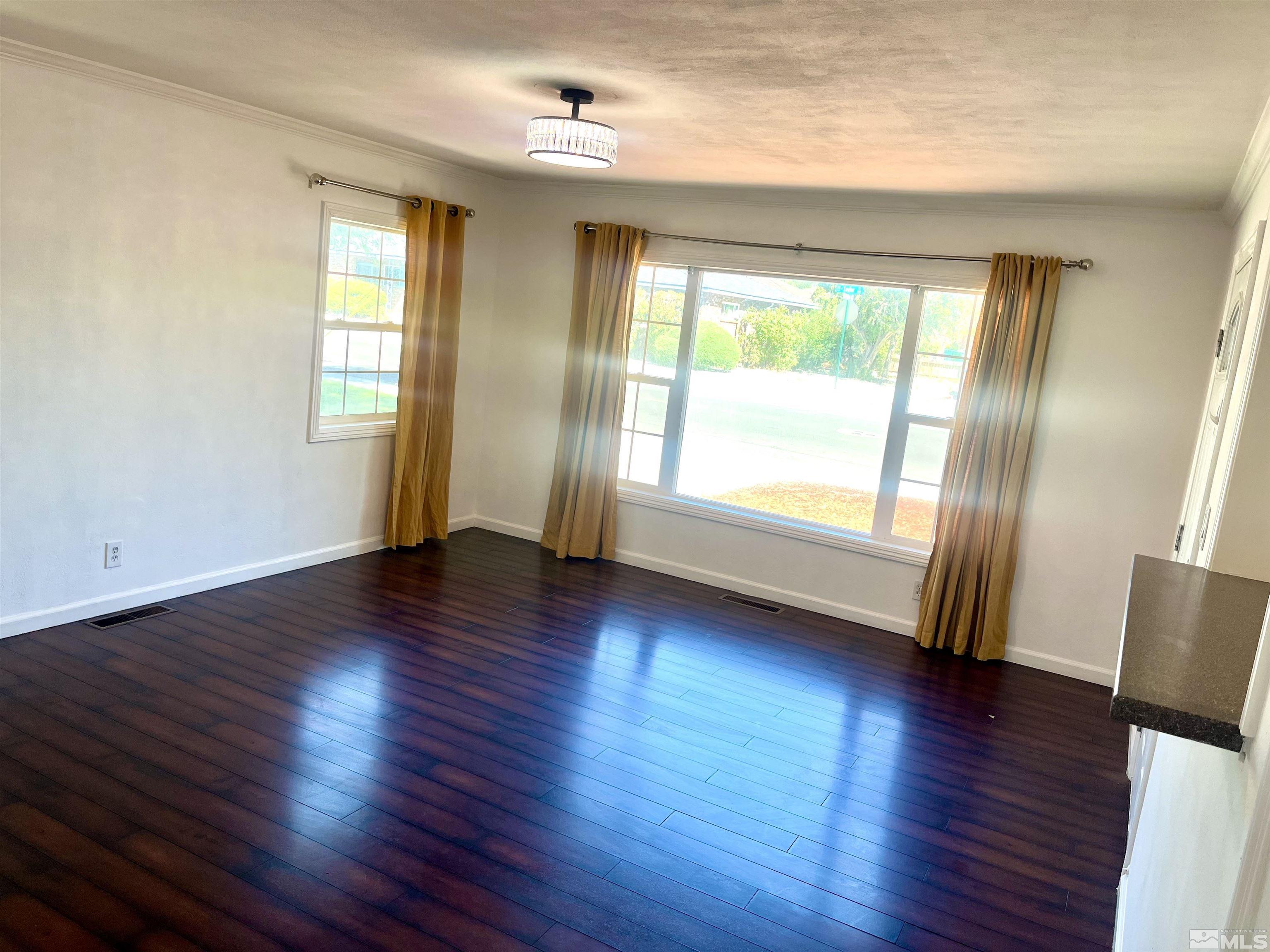 860 East Taylor Street Reno, NV 89502 - Photo 13 of 24 an empty room with wooden floor and windows