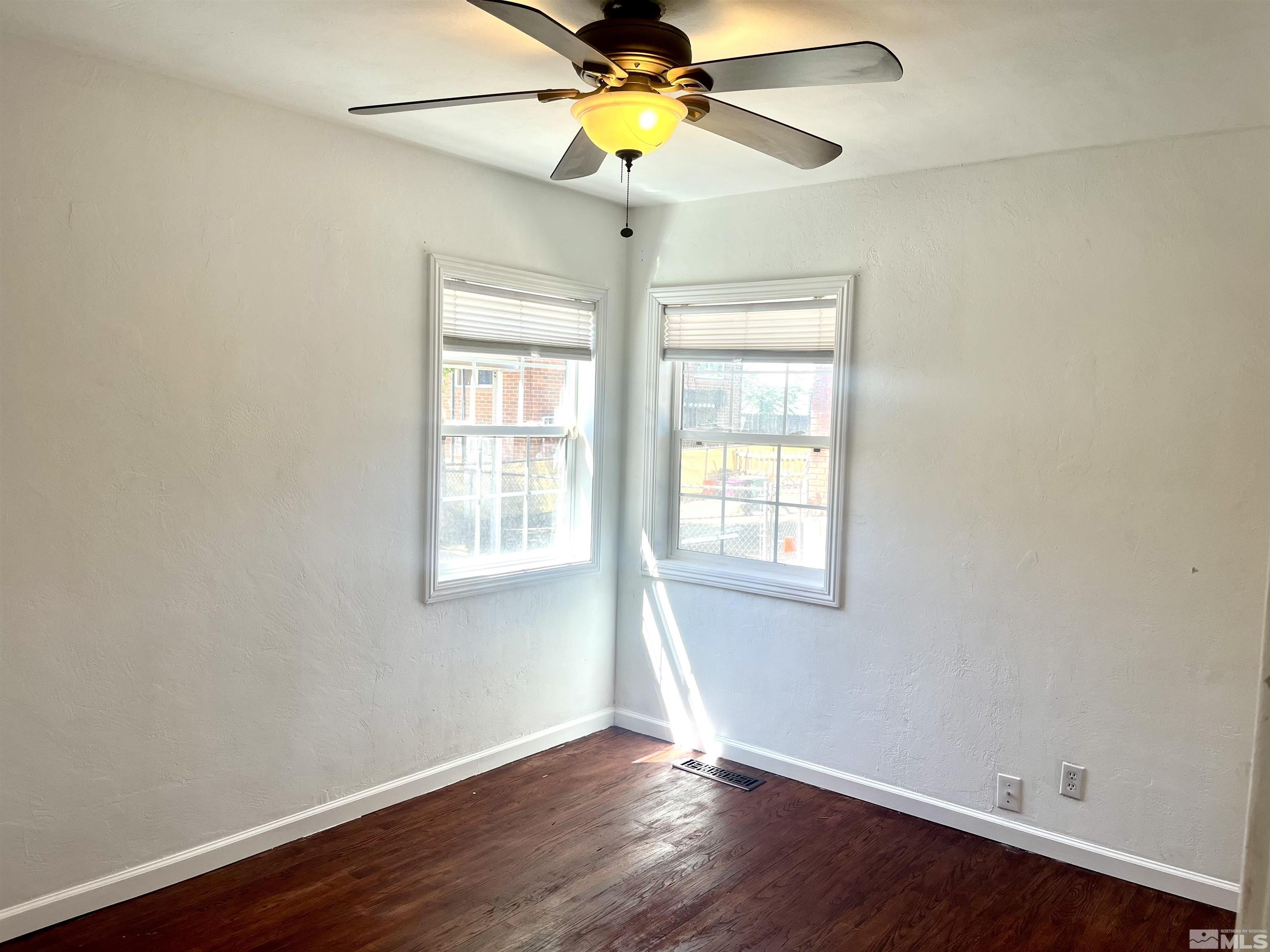 860 East Taylor Street Reno, NV 89502 - Photo 19 of 24 a view of an empty room with window and wooden floor