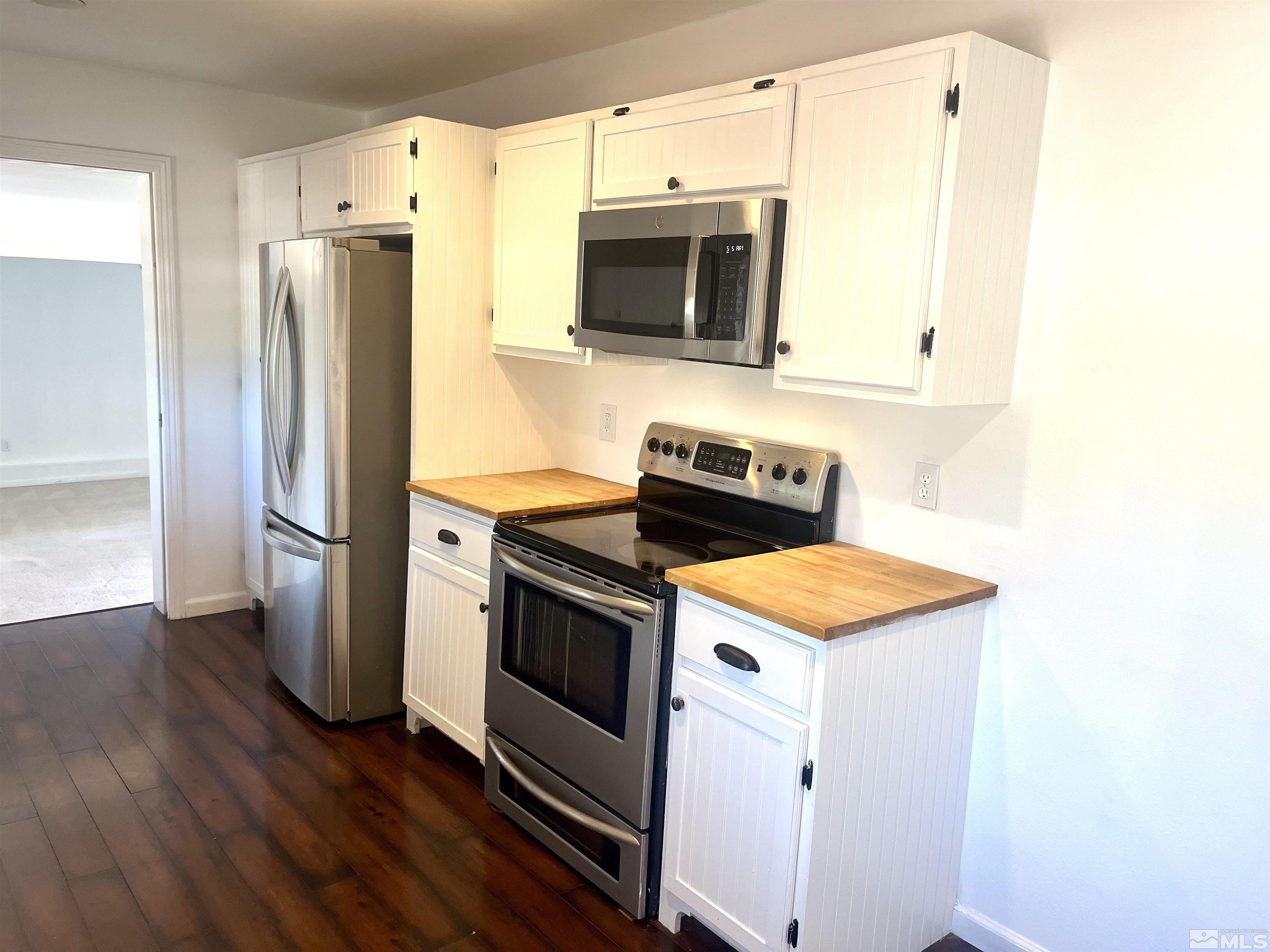 860 East Taylor Street Reno, NV 89502 - Photo 3 of 24 a kitchen with stainless steel appliances a stove a microwave and a refrigerator