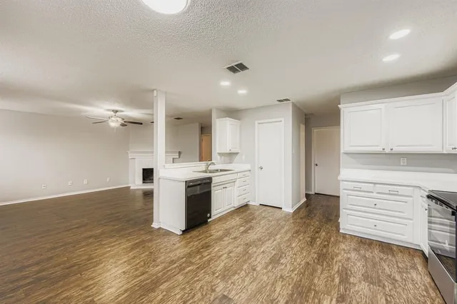 a backyard of a house with lots of green space and trampoline