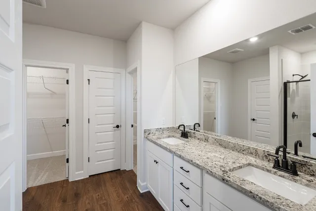 a bathroom with a glass shower door