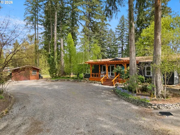 a view of a house with backyard and sitting area
