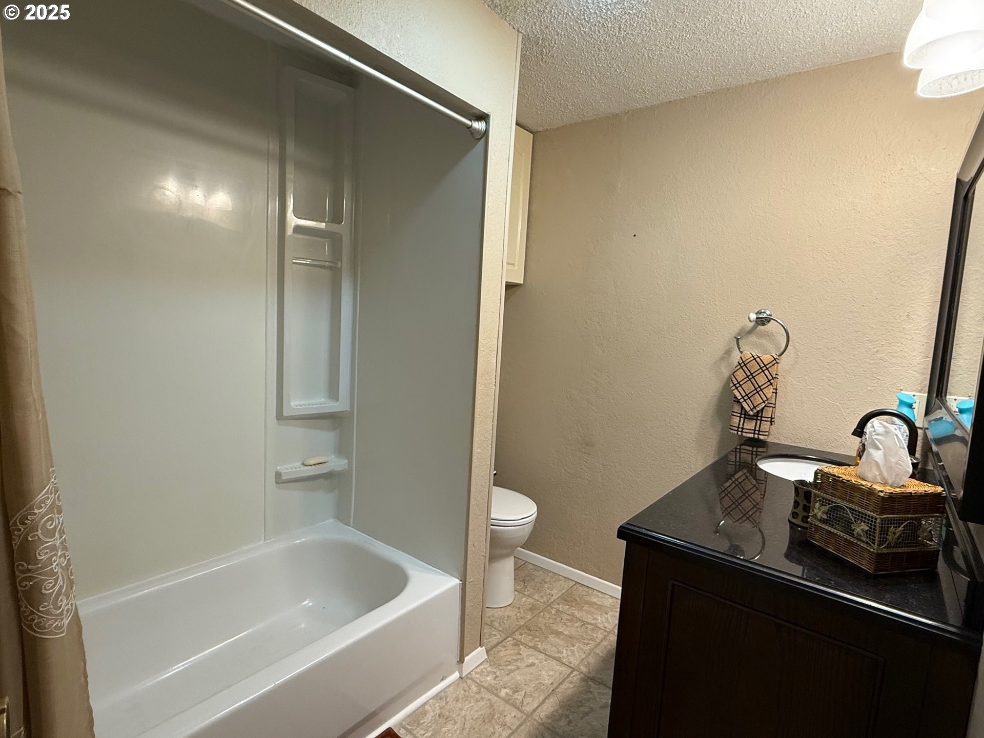 87511 Tiernan Road Mapleton, OR 97453 - Photo 17 of 23 a bathroom with a granite countertop sink a toilet and bathtub