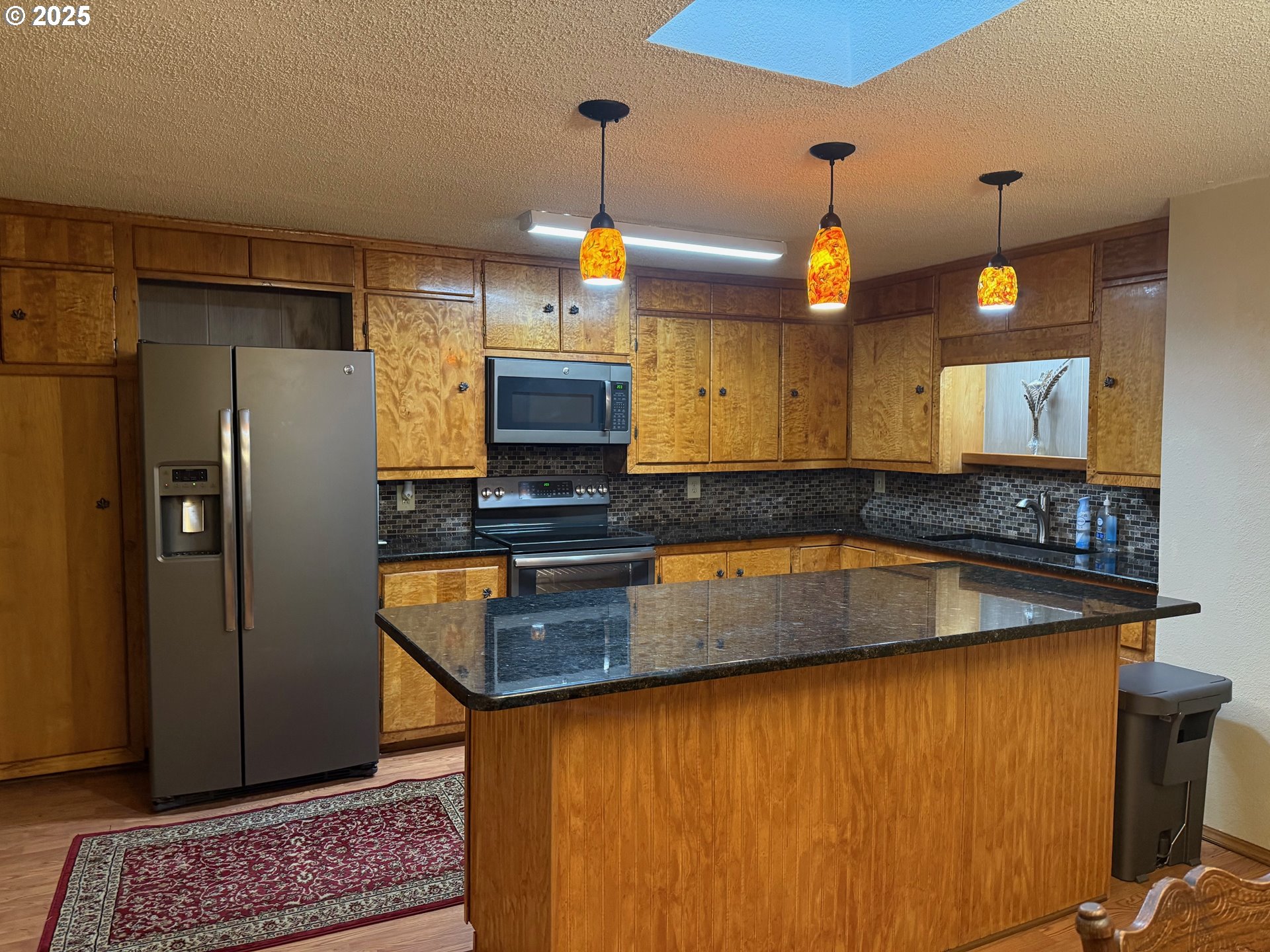 87511 Tiernan Road Mapleton, OR 97453 - Photo 4 of 23 a kitchen with stainless steel appliances granite countertop a refrigerator a sink and a stove