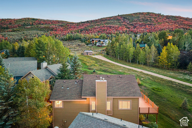 7396 Brook Hollow Loop Road Park City, UT 84098 - Photo 51 of 60 Property featuring a multi-level deck, two chimneys, and an exterior with natural siding
