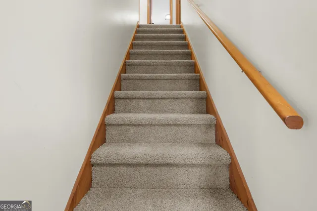 a view of a hallway with wooden shelves