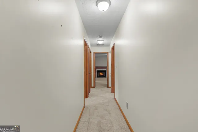 an empty room with a fireplace and window