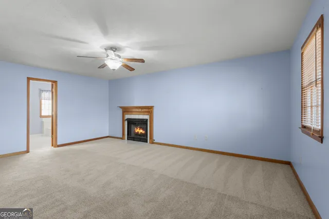 a view of an empty room with a ceiling fan