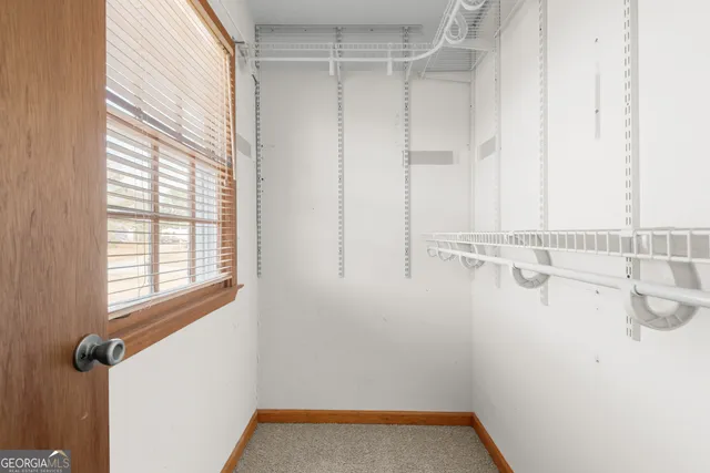 a bathroom with a granite countertop sink a large mirror a toilet and a bathtub