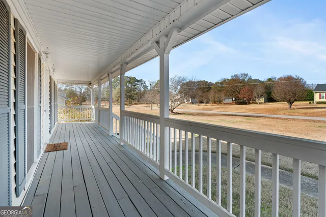 a view of a balcony with wooden floor