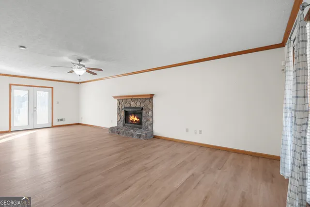 wooden floor in an empty room with a window