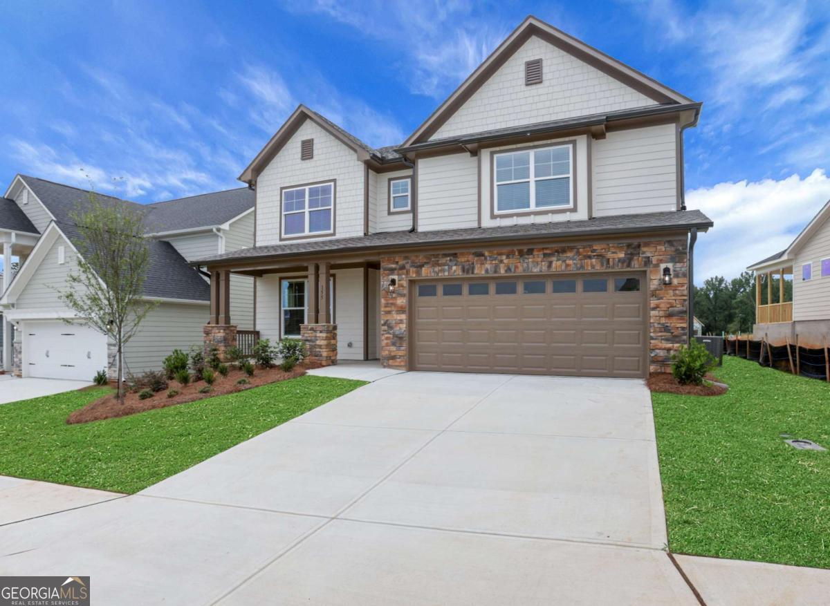a front view of a house with a yard and garage
