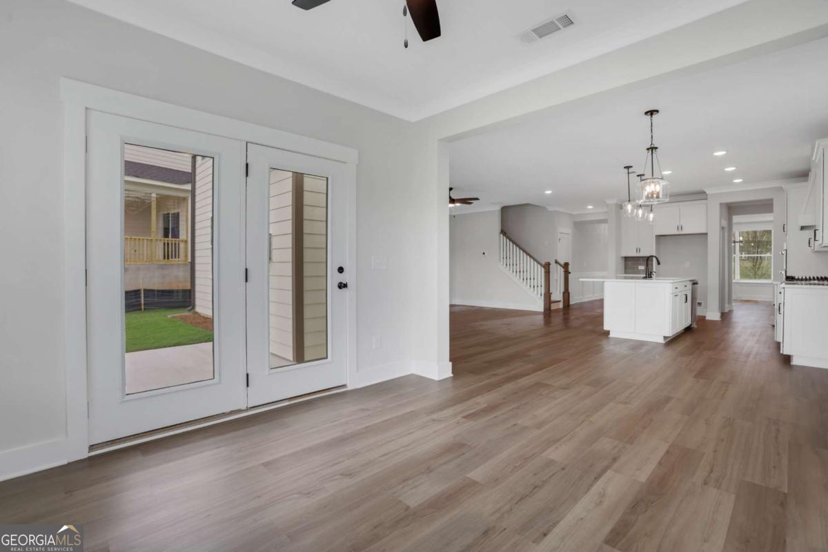 4230 Mary Ruth Way Loganville, GA 30052 - Photo 22 of 51 a view of a living room a kitchen and a wooden floor