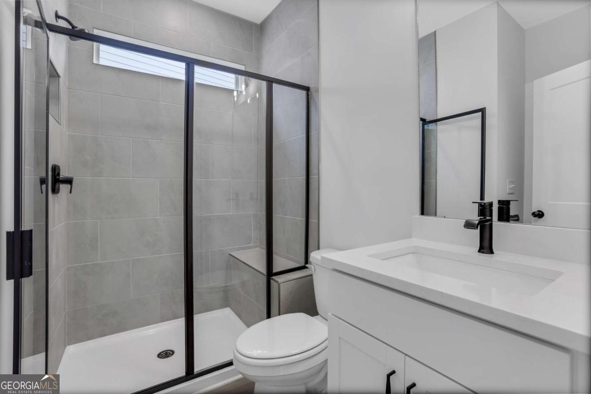 4230 Mary Ruth Way Loganville, GA 30052 - Photo 26 of 51 a bathroom with a sink a toilet and shower