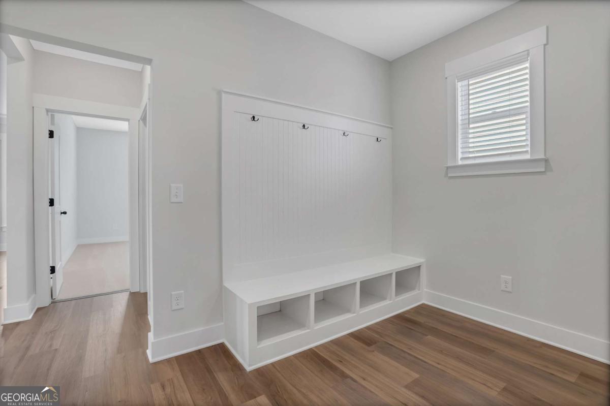 4230 Mary Ruth Way Loganville, GA 30052 - Photo 27 of 51 a view of an empty room with wooden floor and a window