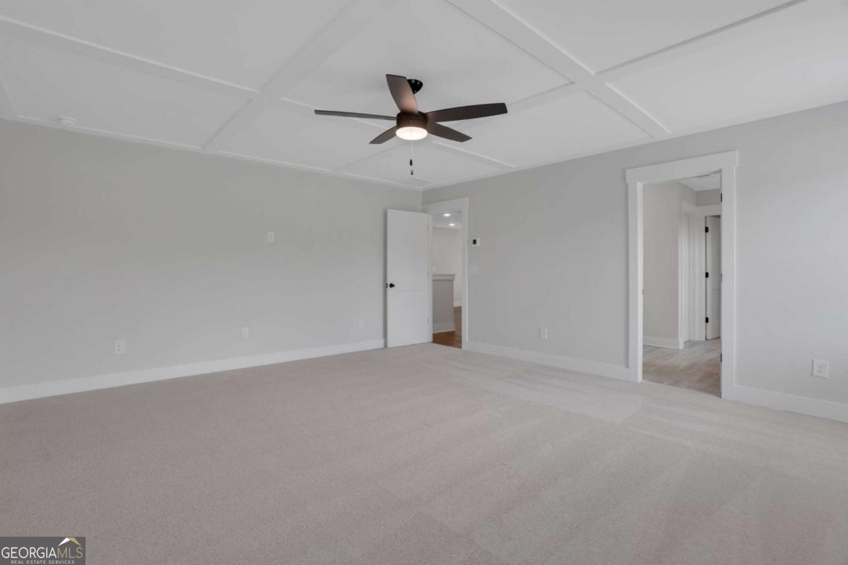 4230 Mary Ruth Way Loganville, GA 30052 - Photo 30 of 51 an empty room with a ceiling fan and a window