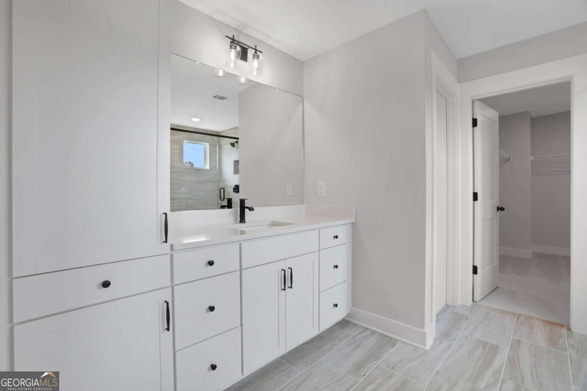 4230 Mary Ruth Way Loganville, GA 30052 - Photo 33 of 51 a bathroom with a double vanity sink and mirror