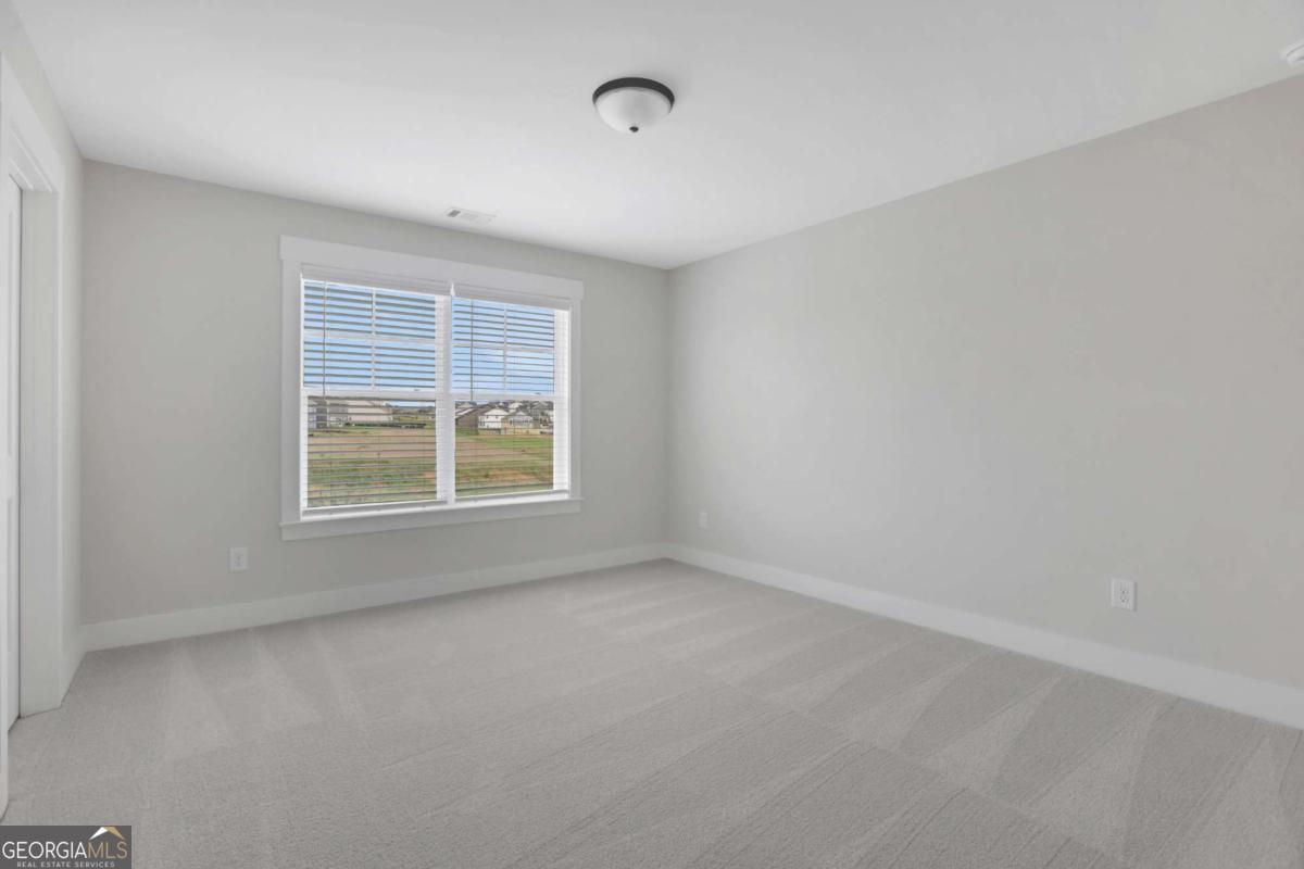 4230 Mary Ruth Way Loganville, GA 30052 - Photo 37 of 51 a view of an empty room with a window