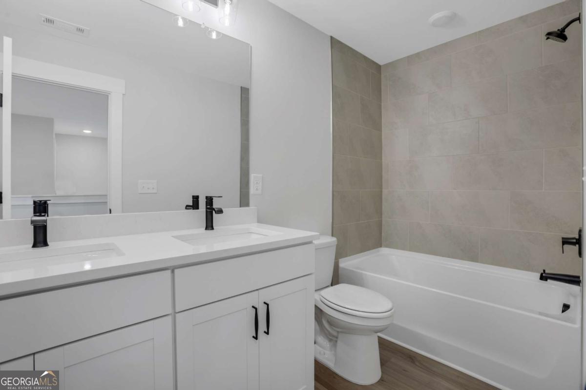 4230 Mary Ruth Way Loganville, GA 30052 - Photo 43 of 51 a bathroom with a sink a toilet and a bathtub