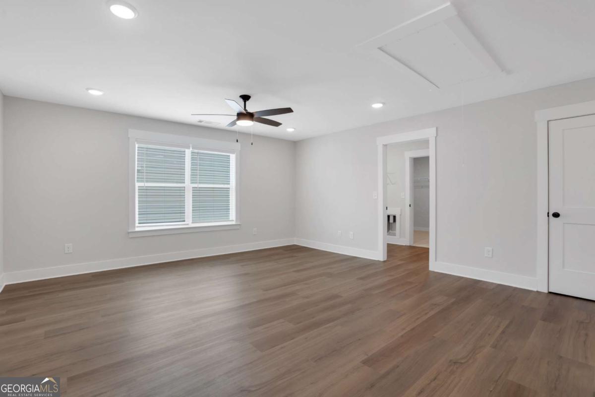 4230 Mary Ruth Way Loganville, GA 30052 - Photo 45 of 51 a view of an empty room with wooden floor and a window