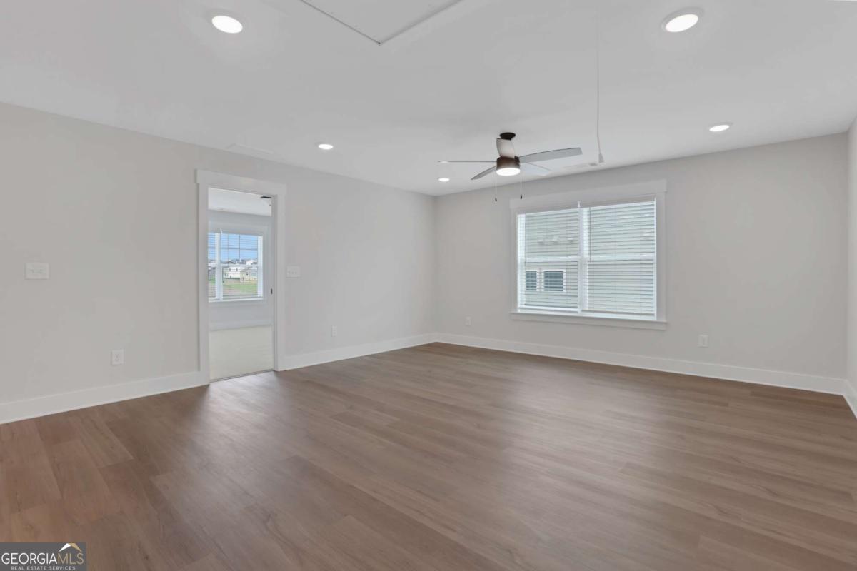4230 Mary Ruth Way Loganville, GA 30052 - Photo 47 of 51 a view of an empty room with a window and wooden floor