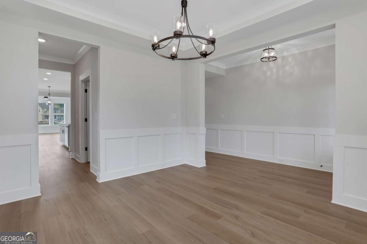 4230 Mary Ruth Way Loganville, GA 30052 - Photo 6 of 51 wooden floor in an empty room with a window