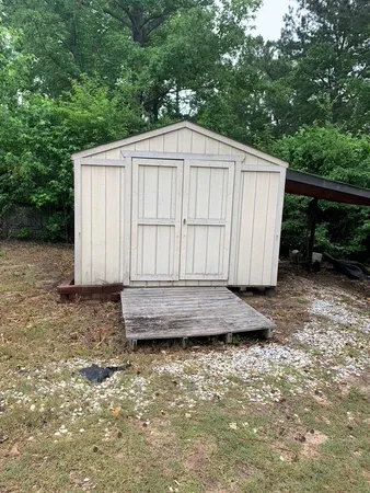 a view of backyard with wooden fence