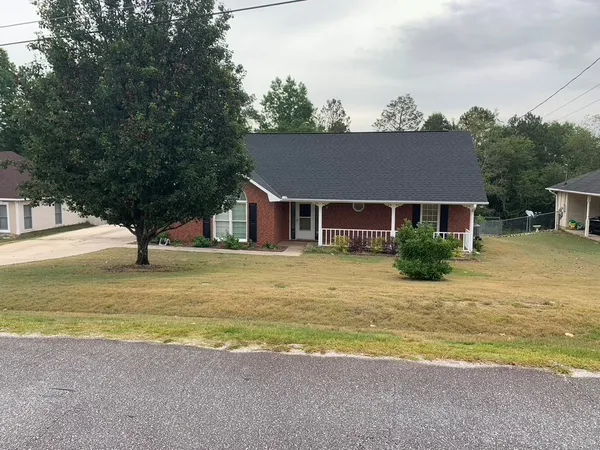 a view of a house with pool and chairs