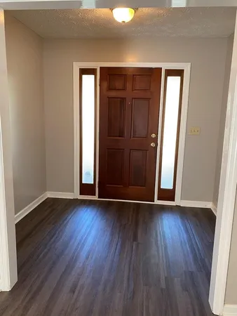 an empty room with wooden floor and closet