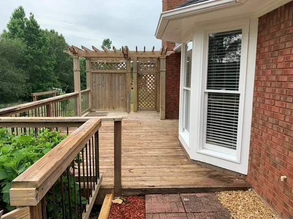 a view of a balcony with wooden floor and fence