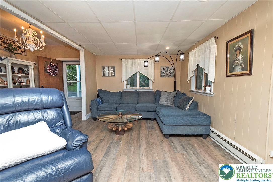1114 Fox Gap Road Bangor, PA 18013 - Photo 24 of 63 Wood-paneled walls and durable laminate flooring create a welcoming and cozy living area.