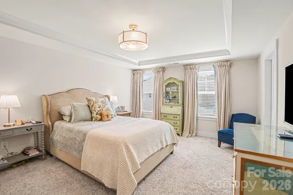 a bedroom with a large bed and a large window